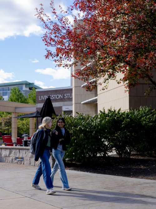 Students walk outside the Student Center on Livingston campus on a fall day
