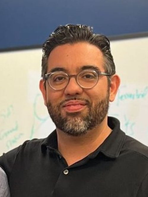 Jorge Ortiz in a black collared shirt