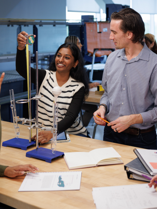 A group of engineering students and a professor working on an activity