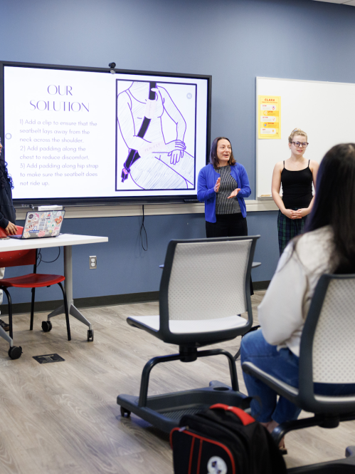 Students presenting a project in front of a classroom