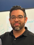 Jorge Ortiz in a black collared shirt