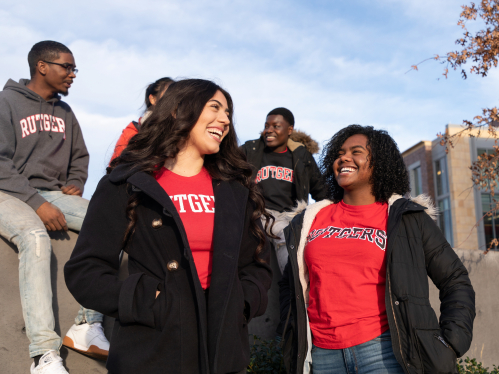 students stand outside talking to each other