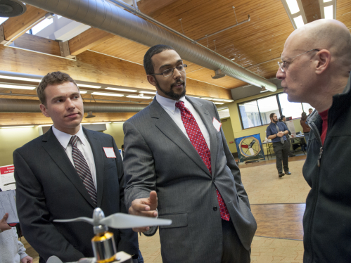 Students explain an engineering project to a visitor at Rutgers Day