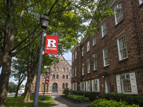 A red Rutgers banner on a post outside of Old Queens
