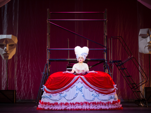 A student onstage performing in "Candide"