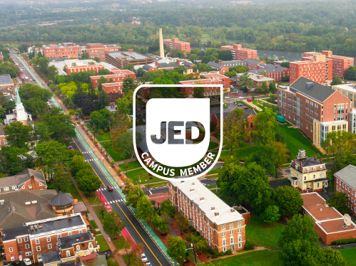 JED Campus Member Seal over an aerial image of New Brunswick