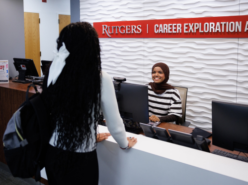 A student speaking with a receptionist at the Office of Career Exploration and Success