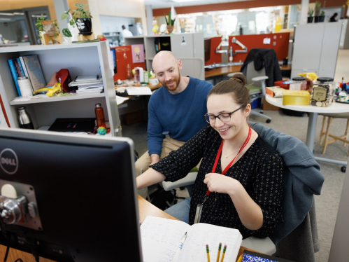 Graduate students working together in an office