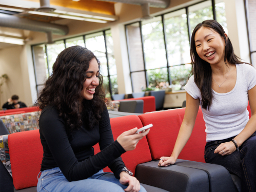 two female students in a lounge