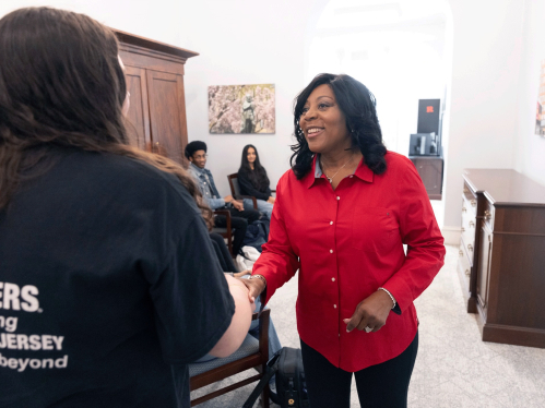 Chancellor Conway shaking hands with a student