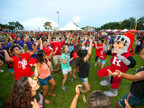 students with the Knight outside dancing