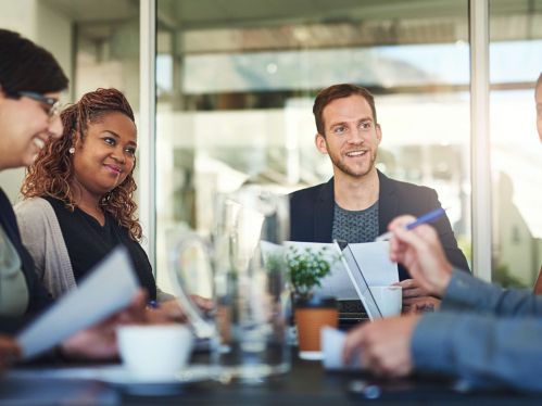 A group of professionals sitting around a table and chatting
