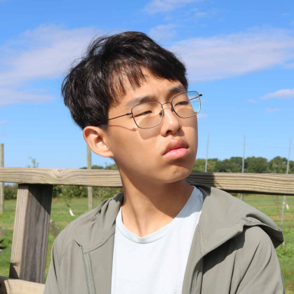 Honors College student Kyle Yoon takes in Synder Farm while riding a wagon towed by a tractor.
