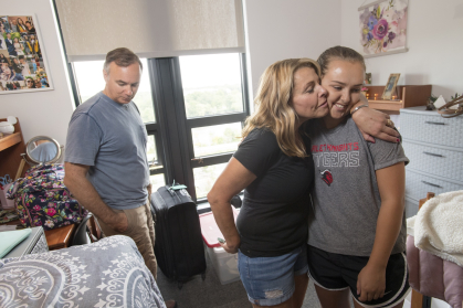 Richard Velez and Lori Velez help their daughter Sarah Velez (SEBS'23) move into Honors College