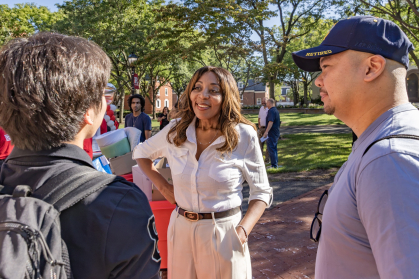 Chancellor Conway speaking to a student wearing a backpack during move-in 2026