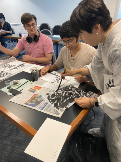 Students in Haruko Wakabayashi’s class participating in a Japanese ink painting workshop.