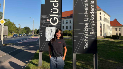 Rutgers student Charlene Guo poses in front of signs at the Technische Universität Bergakademie Freiberg in Saxony, Germany, in August.