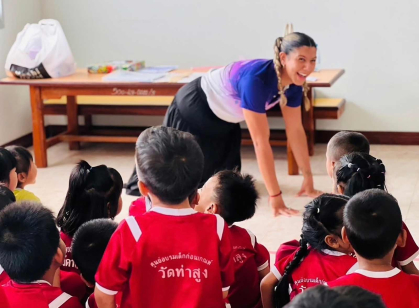 Chelsea A. Fernandez, a Rutgers graduate and Fulbright grant recipient, plays animal charades for school children in Thailand.