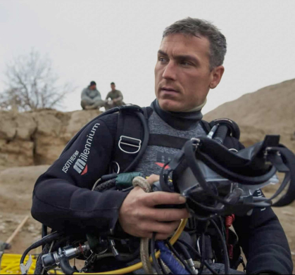 Navy diver Daniel Muhlbach listens to instructions before beginning a dive to search for a missing 82nd Airborne Division soldier in the Murghab River in Afghanistan.