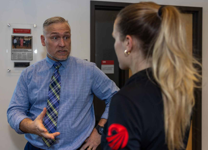 Daniel Muhlbach (left) speaks with behavior analyst Courtney Kenney at the Rutgers Center for Adult Autism Services.