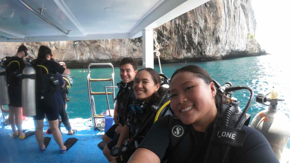 Rutgers medical student Erin Go (right) and other Fulbright recipients prepare to scuba dive off Koh Phi Phi.