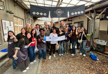 Rutgers graduate Jack Woods (back row, left of center) and members of the New Taipei City cohort pose for a photo while taking part in a traditional clothes-dyeing activity.