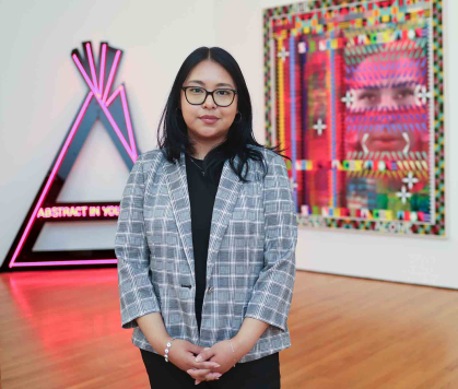 Rutgers New-Brunswick alum Jessie Garcia stands before a Zimmerli exhibition..