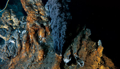 Multi-hued rocks spew black smoke from the ocean floor.