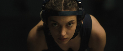 A teenage girl in wrestling gear prepares for a match in a scene from "Wrestle-Off."