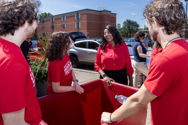 Chancellor Conway speaking to students around a bin during move-in day