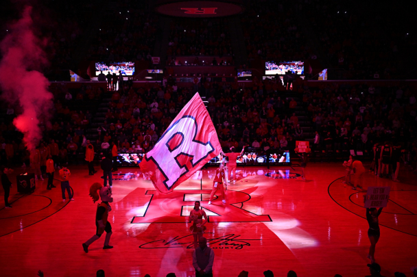 The Rutgers Block R flag being carried around the basketball court