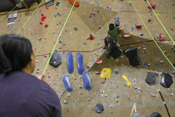 Students climbing the rockwall at the College Avenue Gym