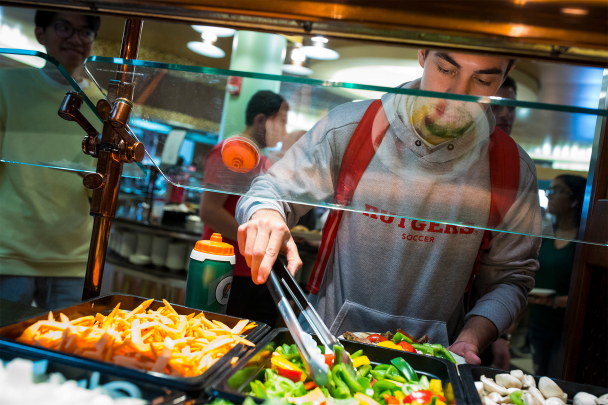 A student partaking in the salad bar at the Livingston Dining Hall