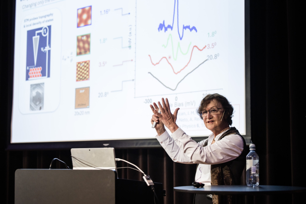 Eva Andrei presenting research in front of a screen