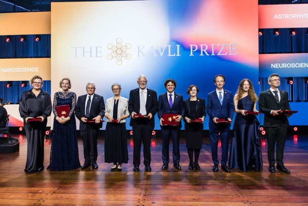 2026 Kavli Prize winners standing together with their awards in front of a colorful background