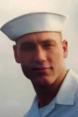 A photo of Daniel Muhlbach was taken onboard the U.S.S. Oak Hill, a dock landing ship of the U.S. Navy, in 1998.