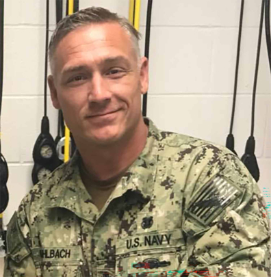 Daniel Muhlbach poses for a photo in a U.S. Navy dive locker in 2020.