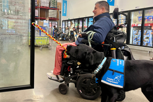 Javier grocery shopping with his service dog