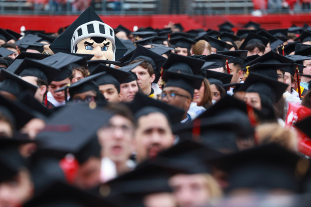 The Scarlet Knight in a crowd of graduates at Commencement