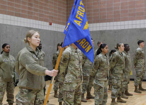 Eden Han, a second-year cadet, acts as guidon flag bearer for the upperclassmen formation, who stand at parade rest before the start of Leadership Laboratory in January at the Sonny Werblin Recreation Center.