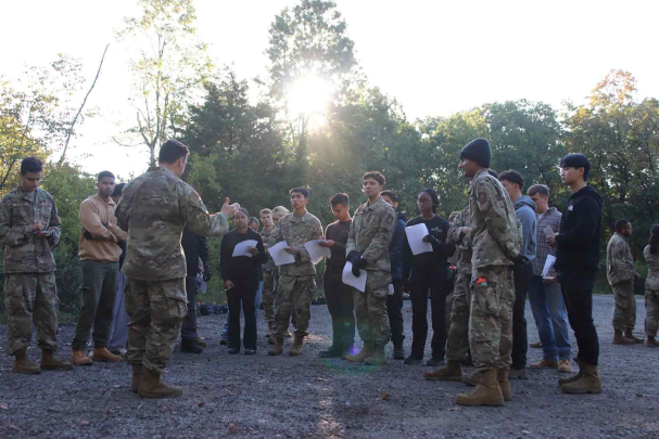 Cadets are briefed on a field scenario in which their teamwork, leadership and problem solving are assessed as part of expeditionary skills training at Kilmer Woods in October.
