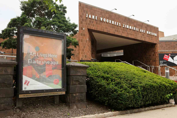 A poster outside the Zimmerli's entrance features messaging in English and Spanish.