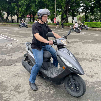 Evan Charles Keeton works on his scooter skills at a practice course in Taichung City.