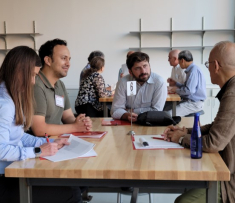A group of people sitting around a table