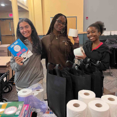 Krupa Shah (left), Ogechi Udechukwu and Omorinsola Ayo-Adebanjo prepare hygiene kits for local nonprofit groups at the Busch Student Center in January 2025.
